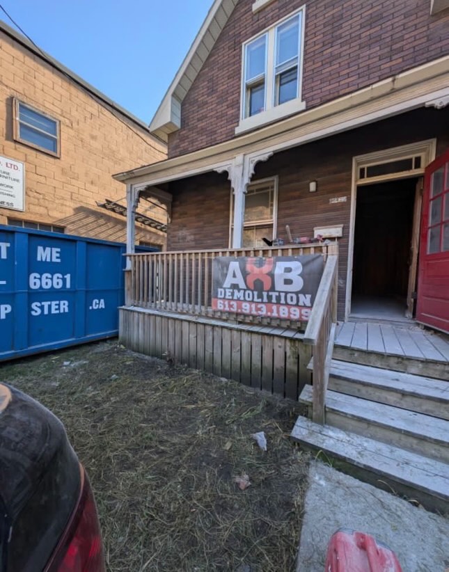 Red brick house with AXB logo