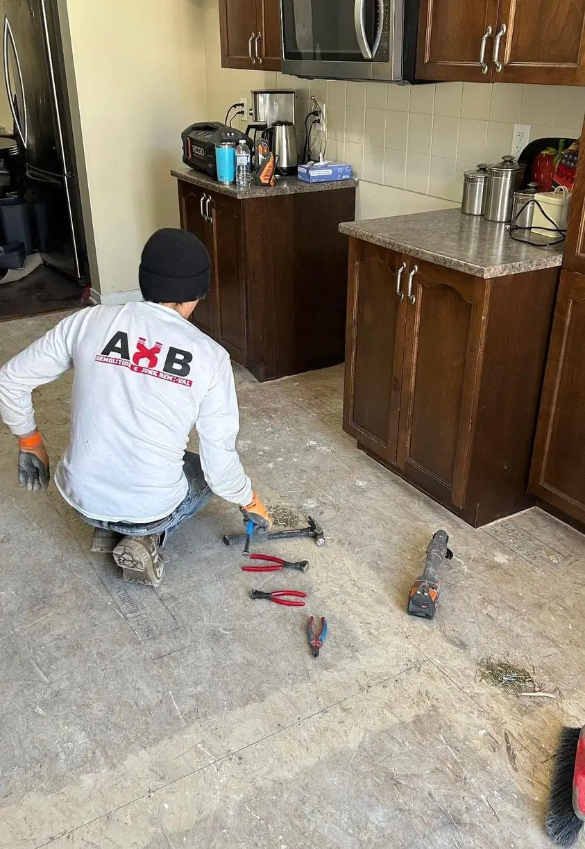 Worker demolishing kitchen floow