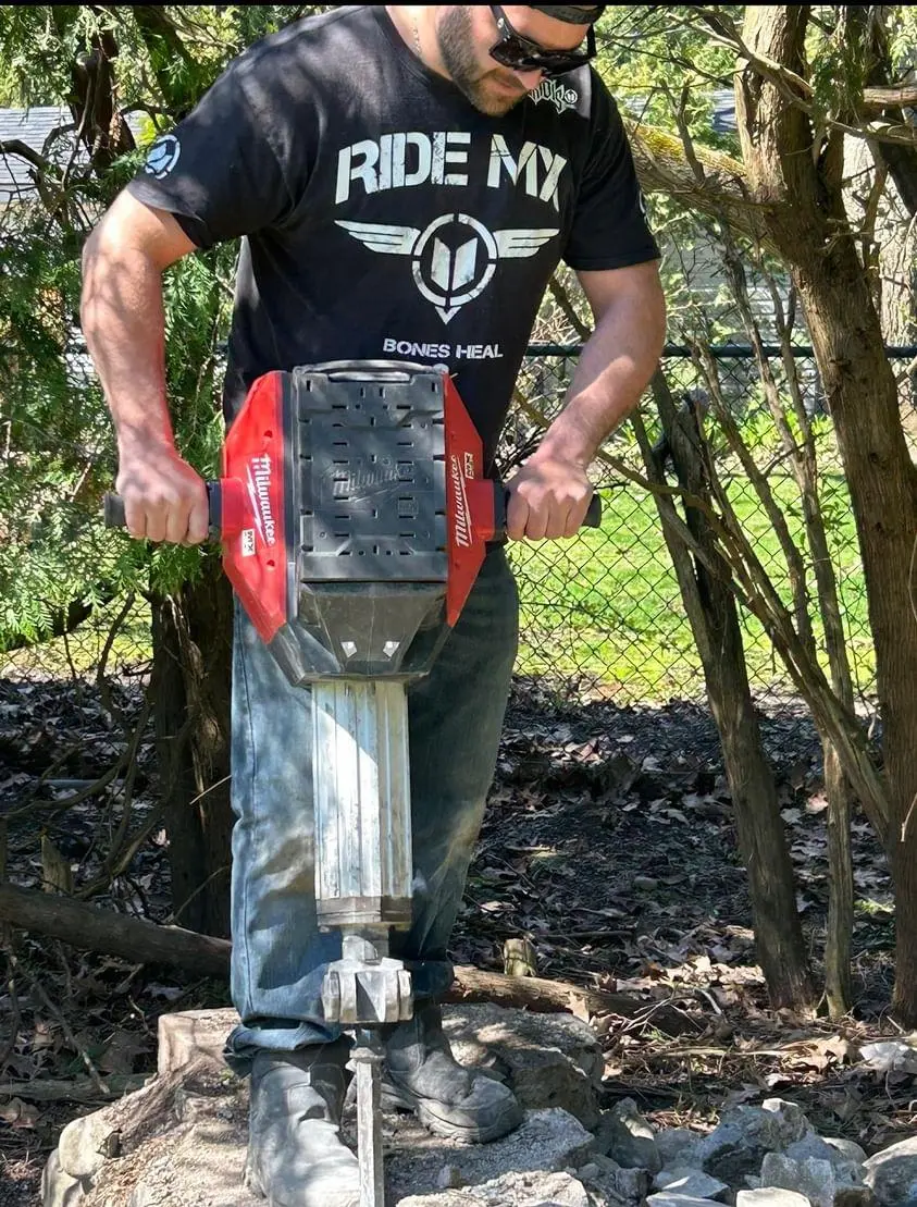 Worker drilling hole in the ground