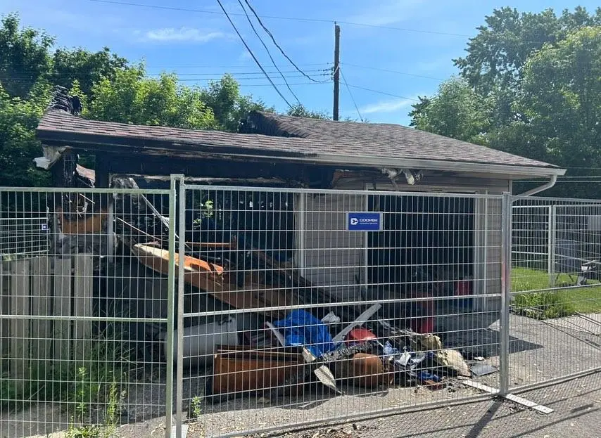 Junk enclosed behind fence